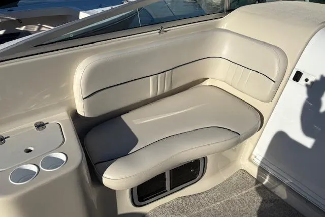 Slide: The Image of 2001 Crownline 242 CR boat interior with beige seating and cup holders. - 29