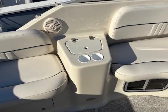 Slide: The Image of 2001 Crownline 242 CR boat interior with beige seating and cup holders. - 30