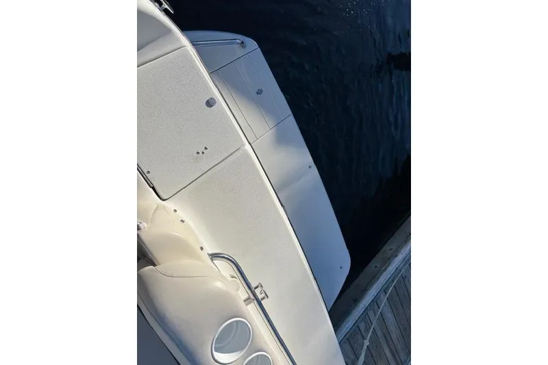 Slide: The Image of 2001 Crownline 242 CR boat deck view by the water. - 34