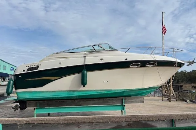 Slide: The Image of 2001 Crownline 242 CR boat on dry dock with American flag in background. - 4