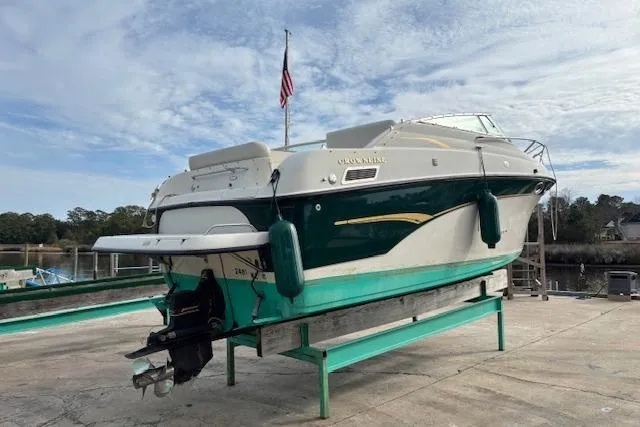Slide: The Image of 2001 Crownline 242 CR boat on dry dock with American flag in background. - 5
