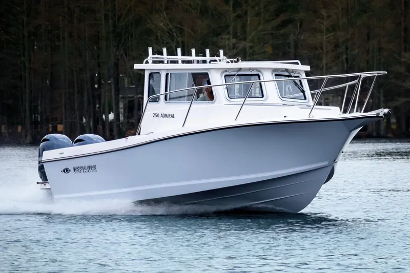 Slide: The Image of Manufacturer Provided Image: 2025 Defiance Admiral 250 EX boat cruising on a calm lake. - 0
