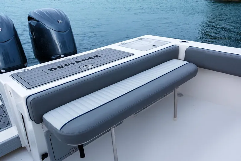 Slide: The Image of Manufacturer Provided Image: 2025 Defiance Admiral 250 EX boat with cushioned seating and dual outboard motors. - 4