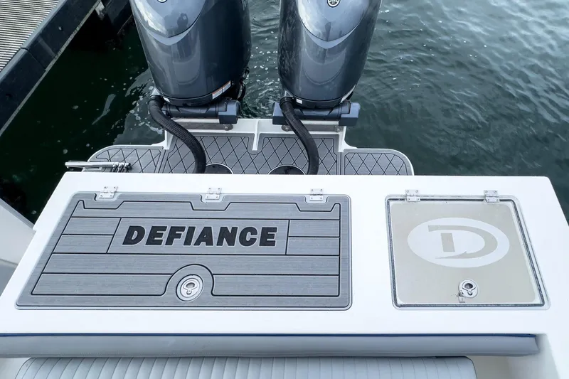 Slide: The Image of Manufacturer Provided Image: 2025 Defiance Admiral 250 EX boat stern with dual engines and branded deck. - 5