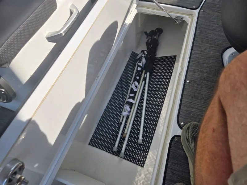Slide: The Image of Storage compartment in a 2021 Scarab 285 ID boat, containing folded equipment. - 14