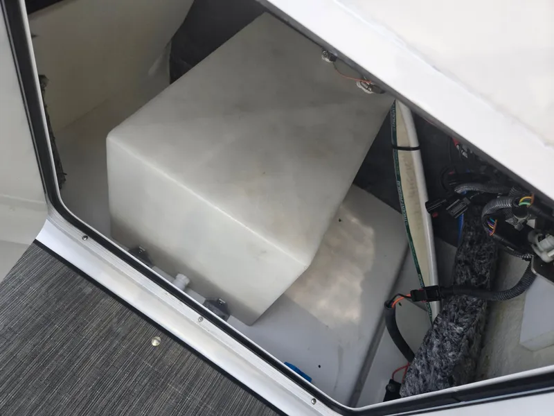 Slide: The Image of 2021 Scarab 285 ID boat storage compartment with wiring and equipment. - 17
