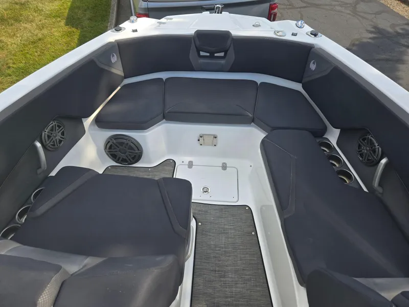 Slide: The Image of 2021 Scarab 285 ID boat interior with cushioned seating and cup holders. - 18