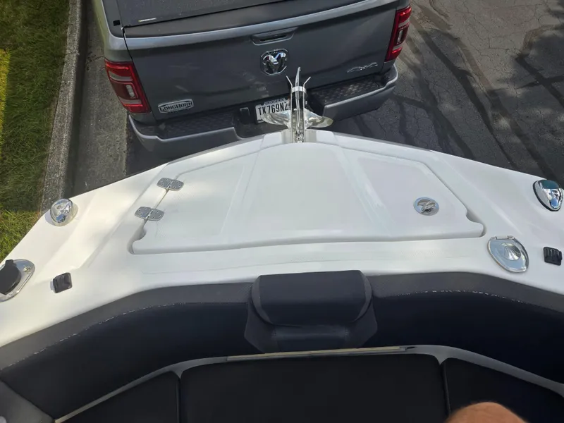 Slide: The Image of Bow of 2021 Scarab 285 ID boat near a parked truck. - 19