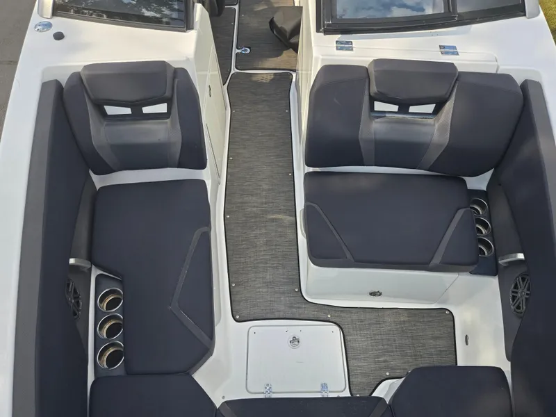 Slide: The Image of 2021 Scarab 285 ID boat interior with black seating and cup holders. - 20