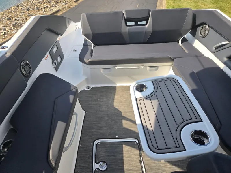 Slide: The Image of 2021 Scarab 285 ID boat interior with seating and table, featuring cup holders and modern design. - 23