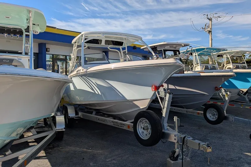 Slide: The Image of 2026 Key West 239 DFS boat on trailer, displayed outdoors under clear sky. - 1