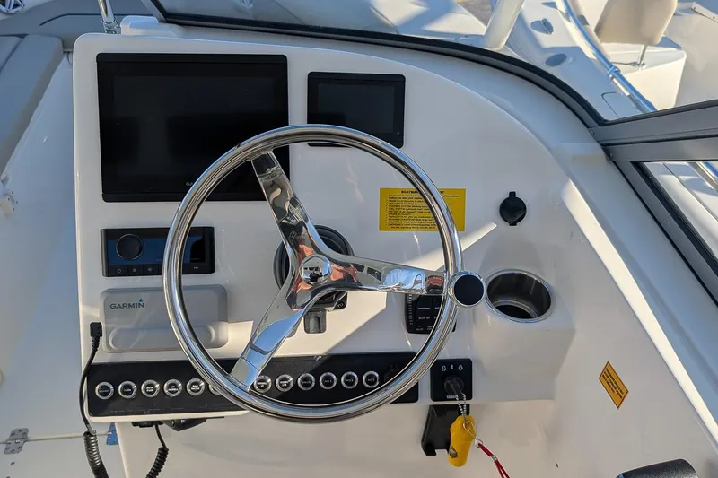 Slide: The Image of Steering console of 2026 Key West 239 DFS boat with Garmin display and controls. - 15