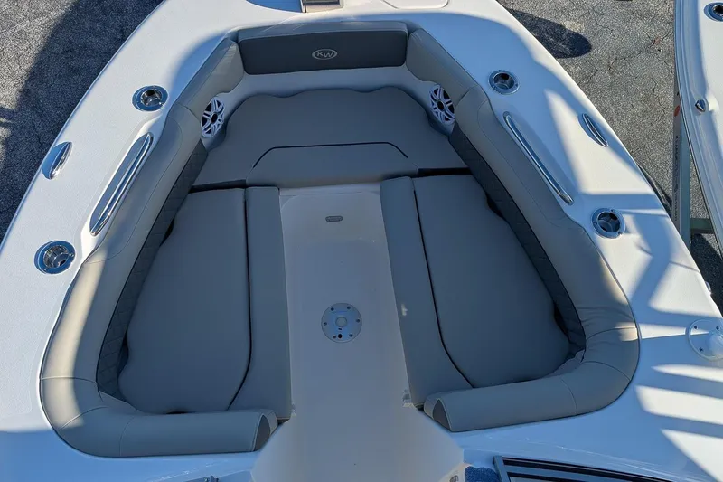 Slide: The Image of 2026 Key West 239 DFS boat interior with cushioned seating and cup holders. - 19