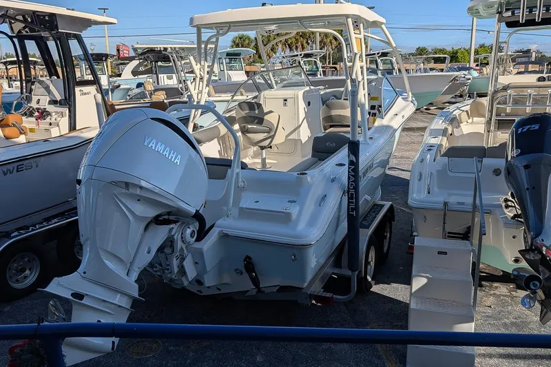 Slide: The Image of 2026 Key West 239 DFS boat with Yamaha outboard engine in a marina. - 2