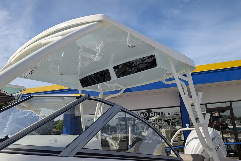 Slide: The Image of 2026 Key West 239 DFS boat with sleek design and modern features under a clear blue sky. - 22