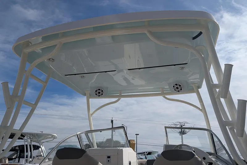 Slide: The Image of 2026 Key West 239 DFS boat with sleek canopy and modern design under a clear sky. - 23