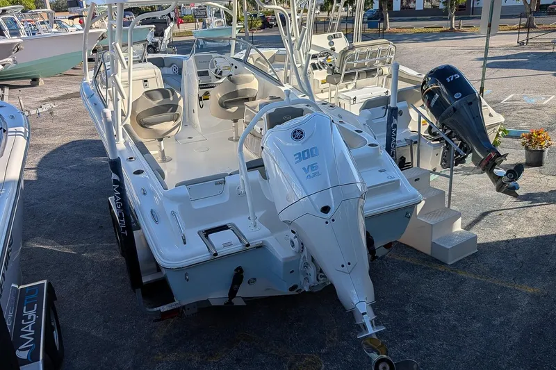 Slide: The Image of 2026 Key West 239 DFS boat with dual outboard engines in a marina setting. - 3