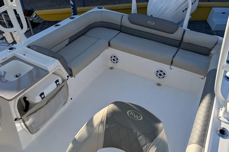 Slide: The Image of 2026 Key West 239 DFS boat interior with cushioned seating and built-in speakers. - 7