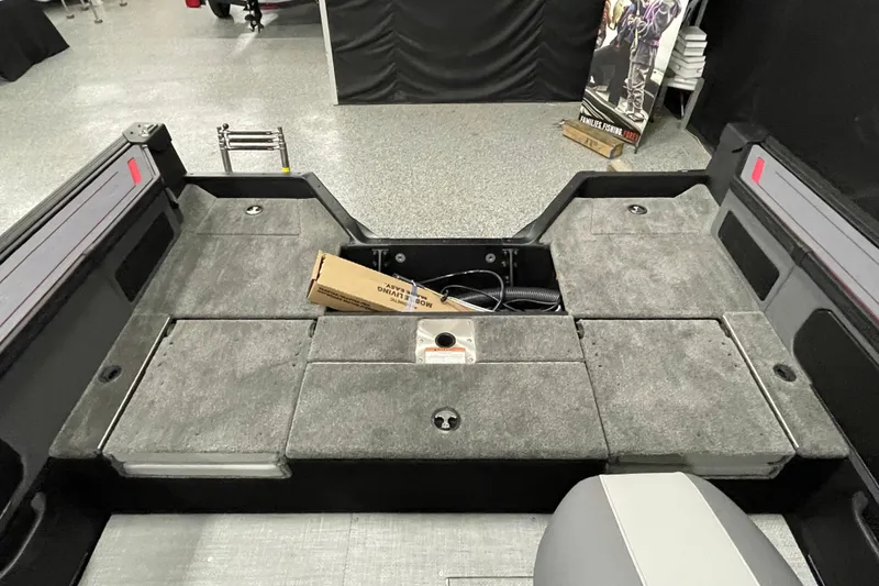 Slide: The Image of 2025 Alumacraft Trophy 175X Sport boat interior with storage compartments and seating. - 14
