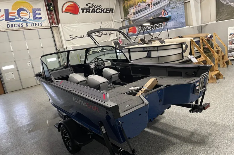 Slide: The Image of 2025 Alumacraft Trophy 175X Sport boat in showroom, featuring sleek design and spacious interior. - 4