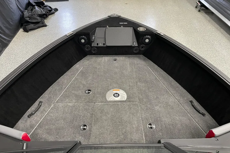 Slide: The Image of 2025 Alumacraft Trophy 175X Sport boat interior with carpeted deck and storage compartments. - 5