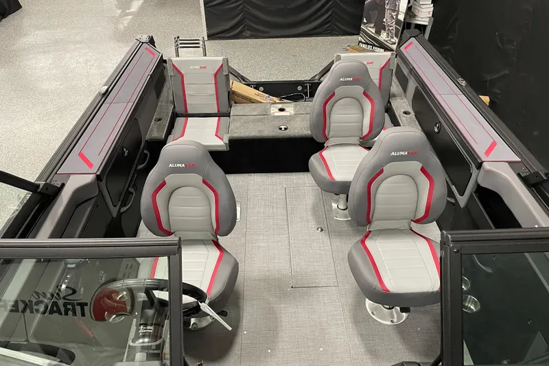 Slide: The Image of 2025 Alumacraft Trophy 175X Sport boat interior with four gray and red seats. - 6