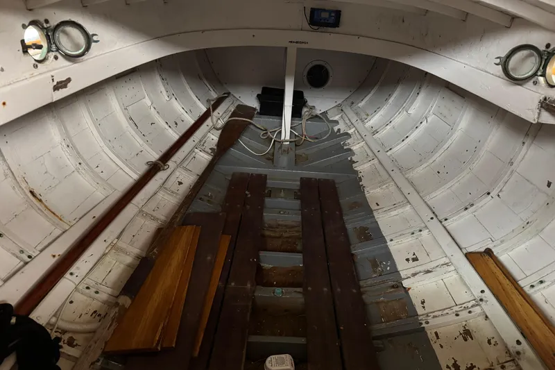 Slide: The Image of Interior of a 1919 Classic Dark Harbor 17 boat, showcasing vintage wooden design. - 5