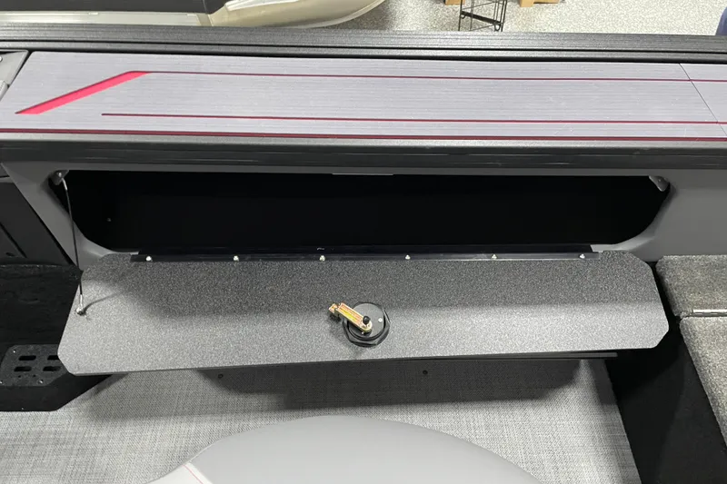 Slide: The Image of 2025 Alumacraft Trophy 185X Sport boat storage compartment with open lid and sleek design. - 11