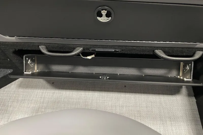 Slide: The Image of 2025 Alumacraft Trophy 185X Sport interior storage compartment with open drawer and handles. - 12