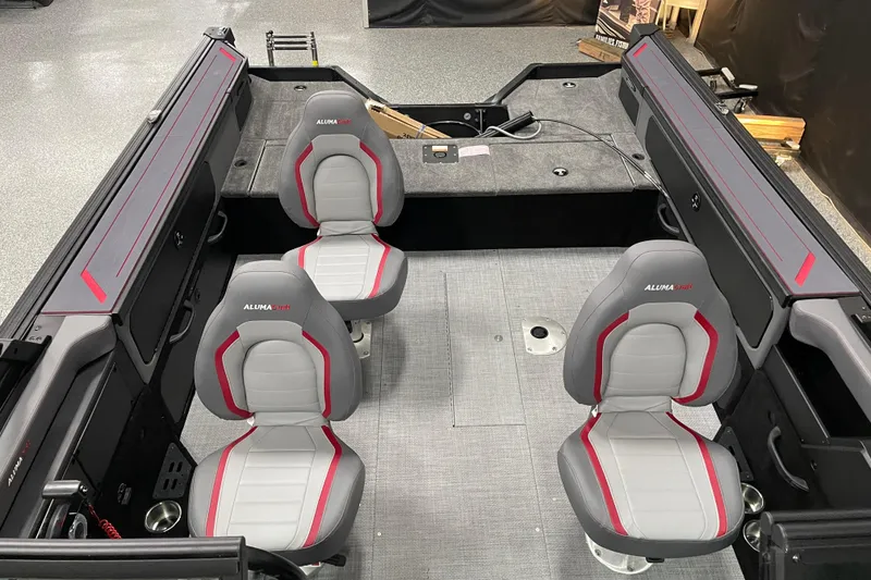 Slide: The Image of 2025 Alumacraft Trophy 185X Sport interior with four gray and red seats. - 4