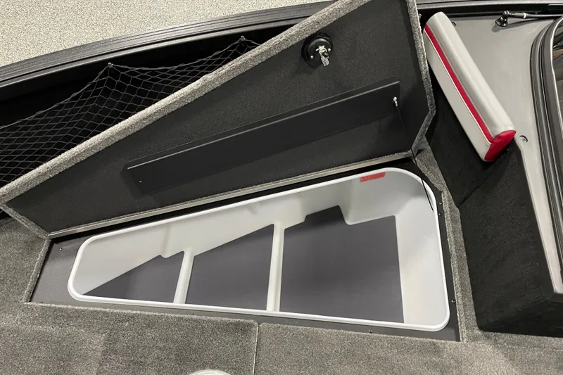 Slide: The Image of 2025 Alumacraft Trophy 185X Sport storage compartment with open lid and netting. - 7