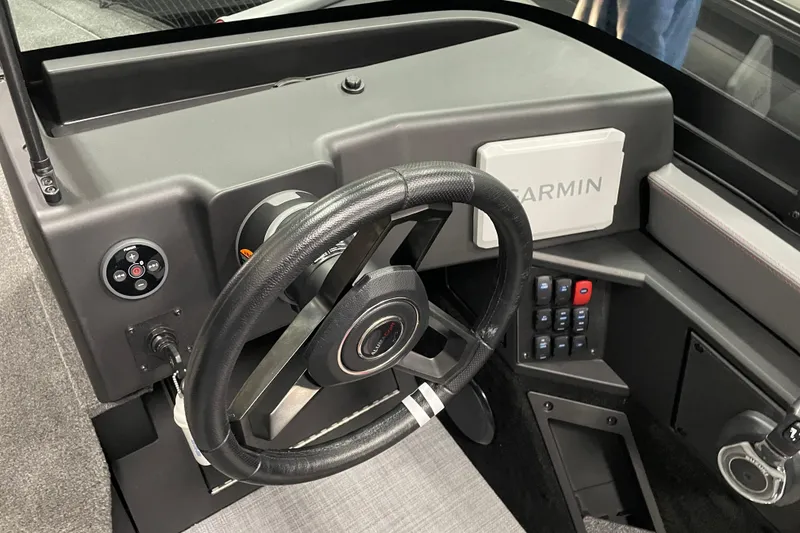 Slide: The Image of 2025 Alumacraft Trophy 185X Sport dashboard with steering wheel and Garmin navigation system. - 8