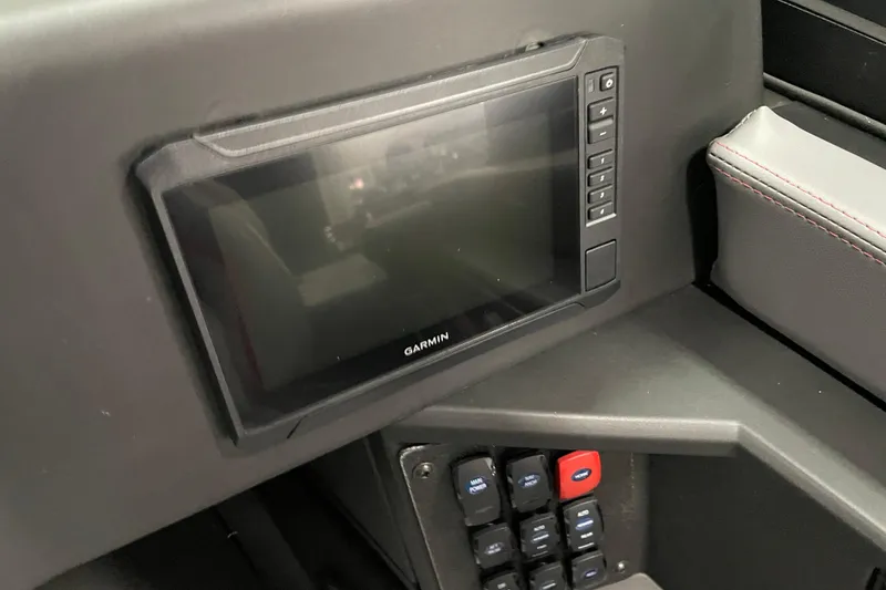 Slide: The Image of 2025 Alumacraft Trophy 185X Sport dashboard with Garmin display and control panel. - 9