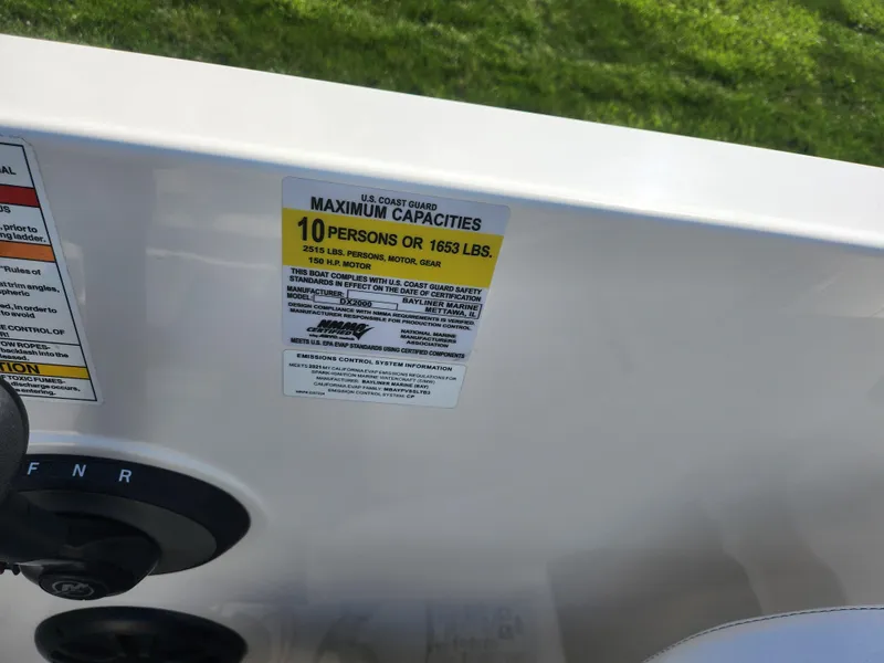 Slide: The Image of Bayliner DX 2000 boat capacity label, 2021 model, showing maximum capacity of 10 persons or 1653 lbs. - 15