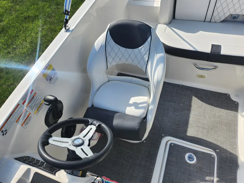 Slide: The Image of Captain's seat and steering wheel of 2021 Bayliner DX 2000 boat interior. - 22