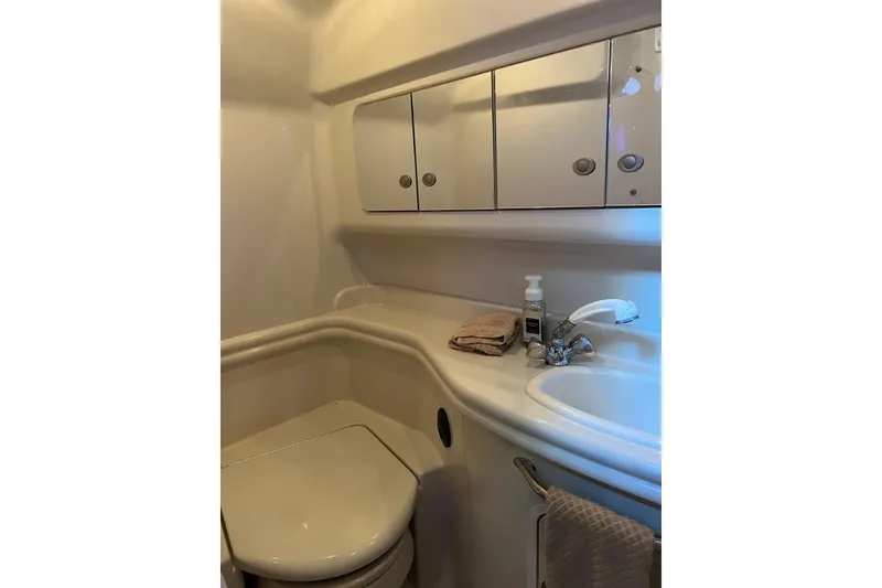 Slide: The Image of 2006 Sea Ray 340 Sundancer bathroom with sink, mirror, and storage cabinets. - 10