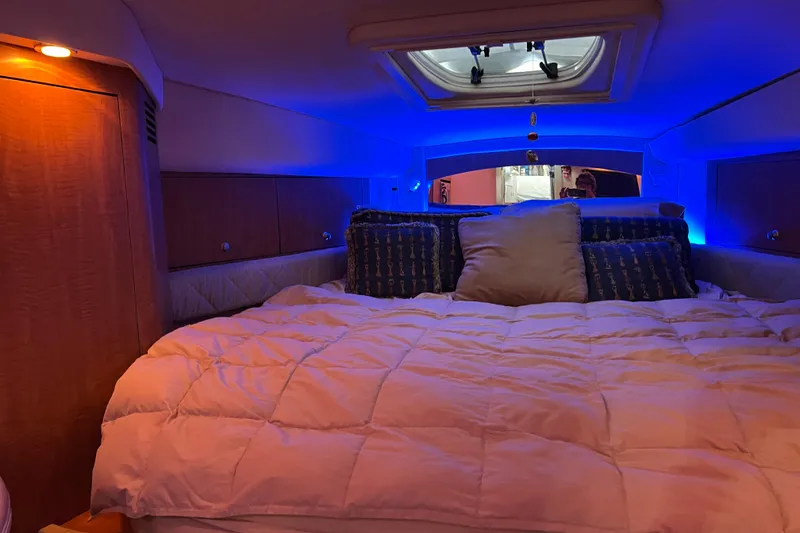 Slide: The Image of Luxurious cabin interior of 2006 Sea Ray 340 Sundancer with cozy bedding and ambient lighting. - 9