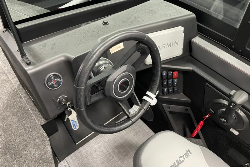 Slide: The Image of 2025 Alumacraft Trophy 185X Sport boat dashboard with steering wheel and Garmin display. - 10
