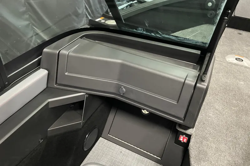 Slide: The Image of 2025 Alumacraft Trophy 185X Sport interior dashboard and storage compartment. - 12
