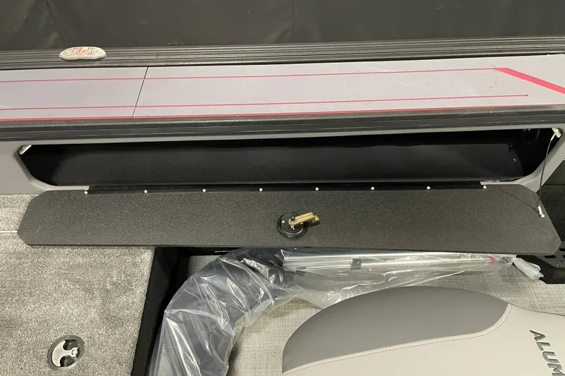 Slide: The Image of 2025 Alumacraft Trophy 185X Sport boat interior storage compartment with key. - 15