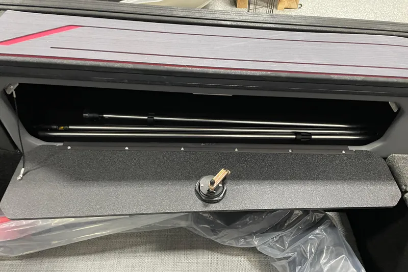 Slide: The Image of 2025 Alumacraft Trophy 185X Sport rod storage compartment with secure latch and sleek design. - 16