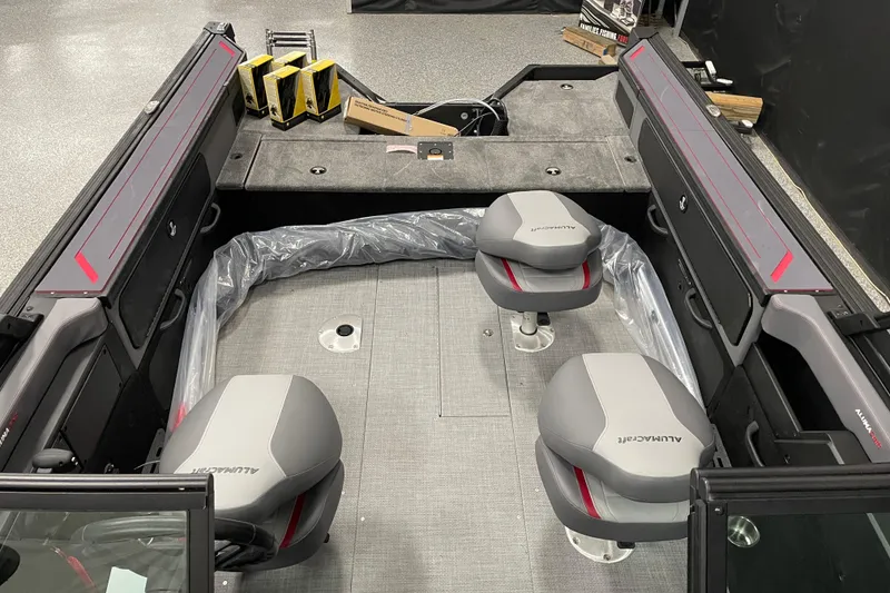 Slide: The Image of 2025 Alumacraft Trophy 185X Sport interior with dual seats and storage compartments. - 6