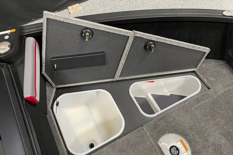 Slide: The Image of 2025 Alumacraft Trophy 185X Sport boat storage compartments with open lids and interior view. - 8