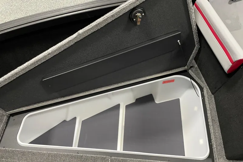 Slide: The Image of 2025 Alumacraft Trophy 185X Sport boat storage compartment, open with visible interior. - 9