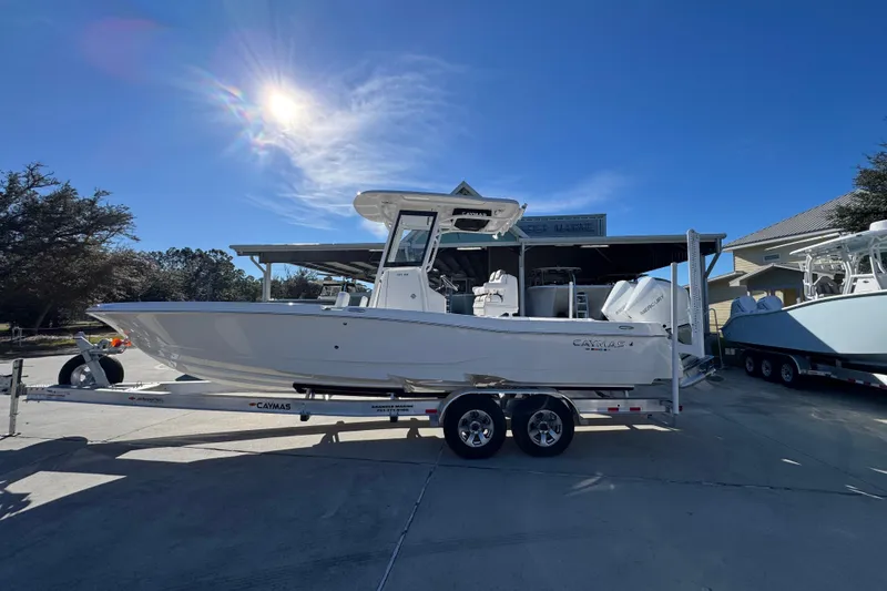 The Image of 2026 Caymas 281 HB boat on trailer under clear blue sky. - 1