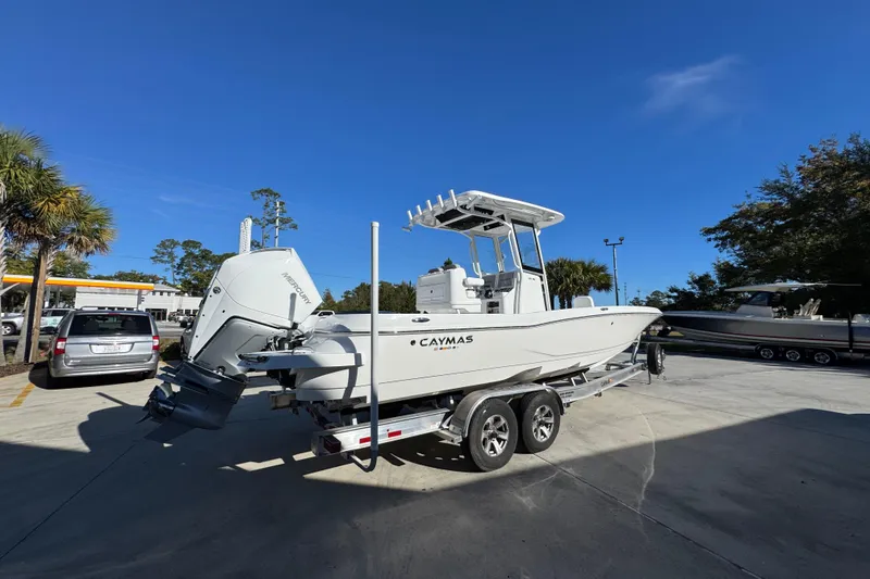 Slide: The Image of 2026 Caymas 281 HB boat on trailer, parked outdoors under clear blue sky. - 13