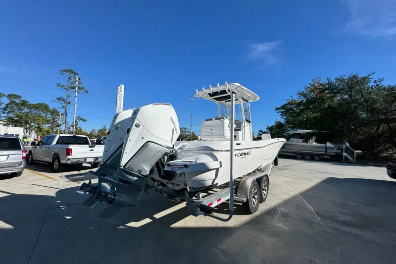 Slide: The Image of 2026 Caymas 281 HB boat on trailer in parking lot under clear blue sky. - 14