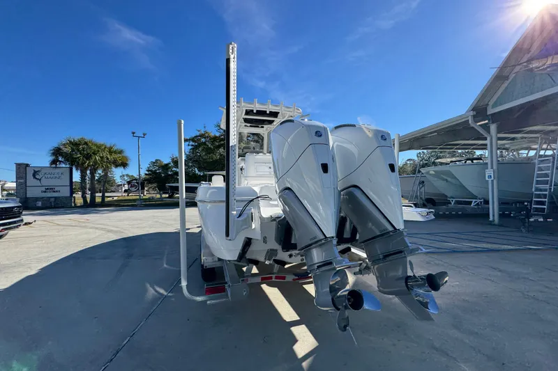 Slide: The Image of 2026 Caymas 281 HB boat with dual outboard motors in a marina setting. - 17