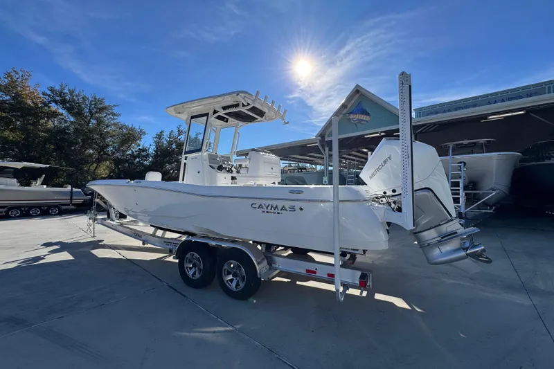 Slide: The Image of 2026 Caymas 281 HB boat on trailer under sunny sky at marina. - 19