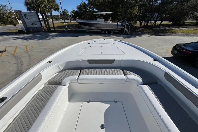 Slide: The Image of 2026 Caymas 281 HB boat interior with cushioned seating and storage compartments. - 21